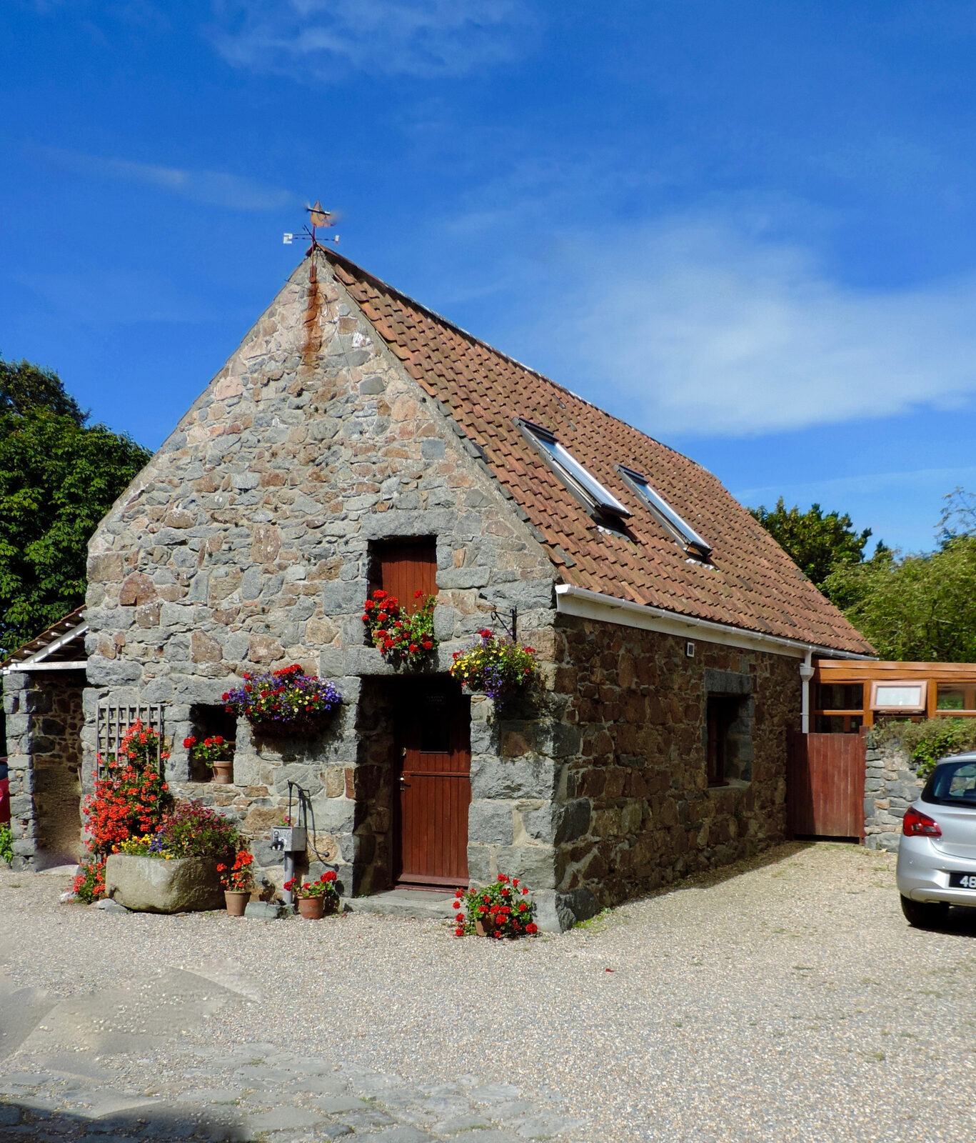 Geranium Cottage's granite exterior and flower-filled entrance