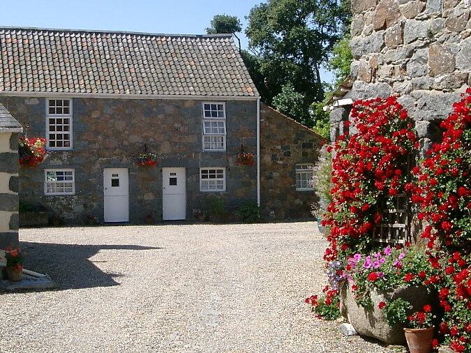 Geranium Cottage garden and outdoor seating at Les Buttes